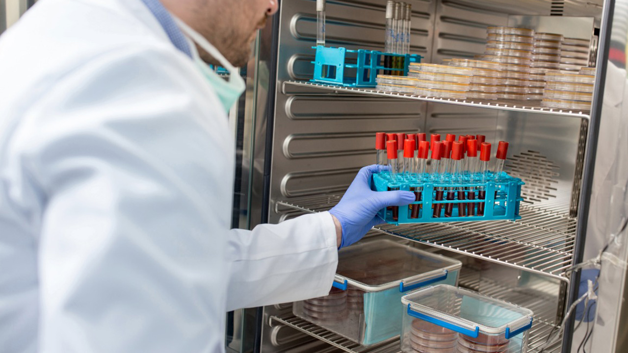 Life Science Use Cases | Man putting blood sample in fridge | Blood Storage | Sample Cold Storage